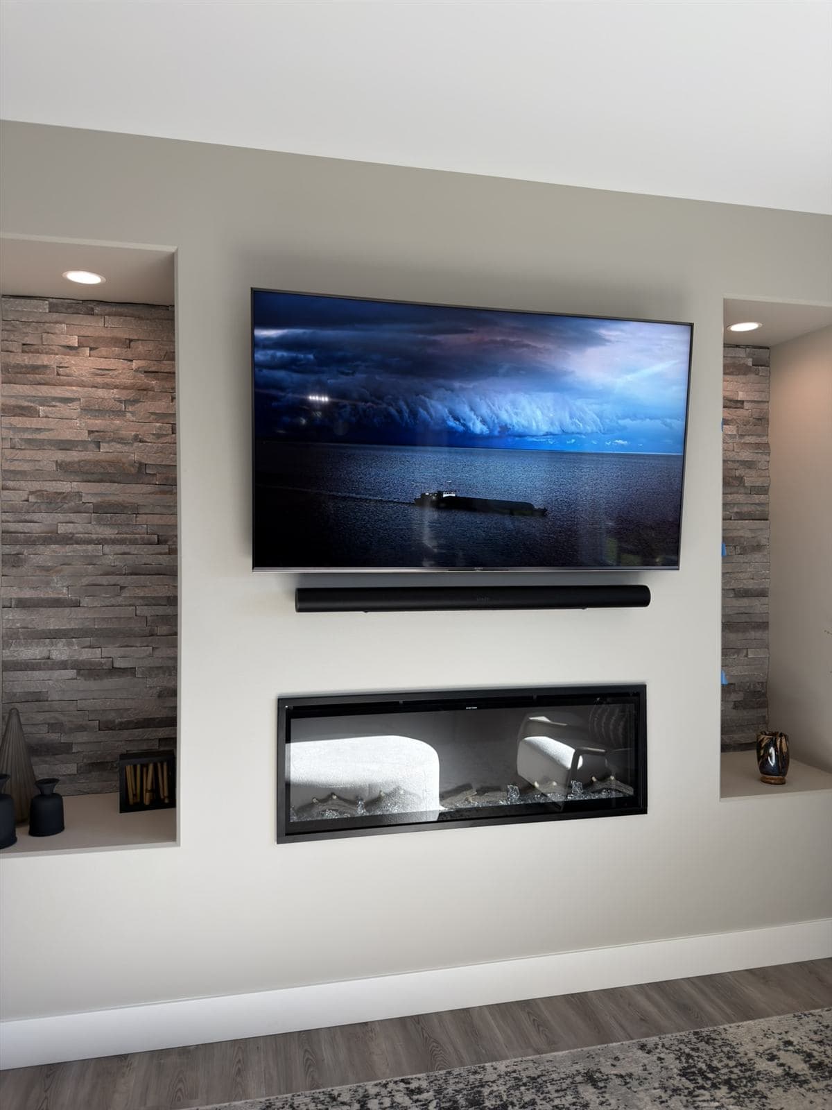 Mounted TV and Sonos Arc above a linear fireplace