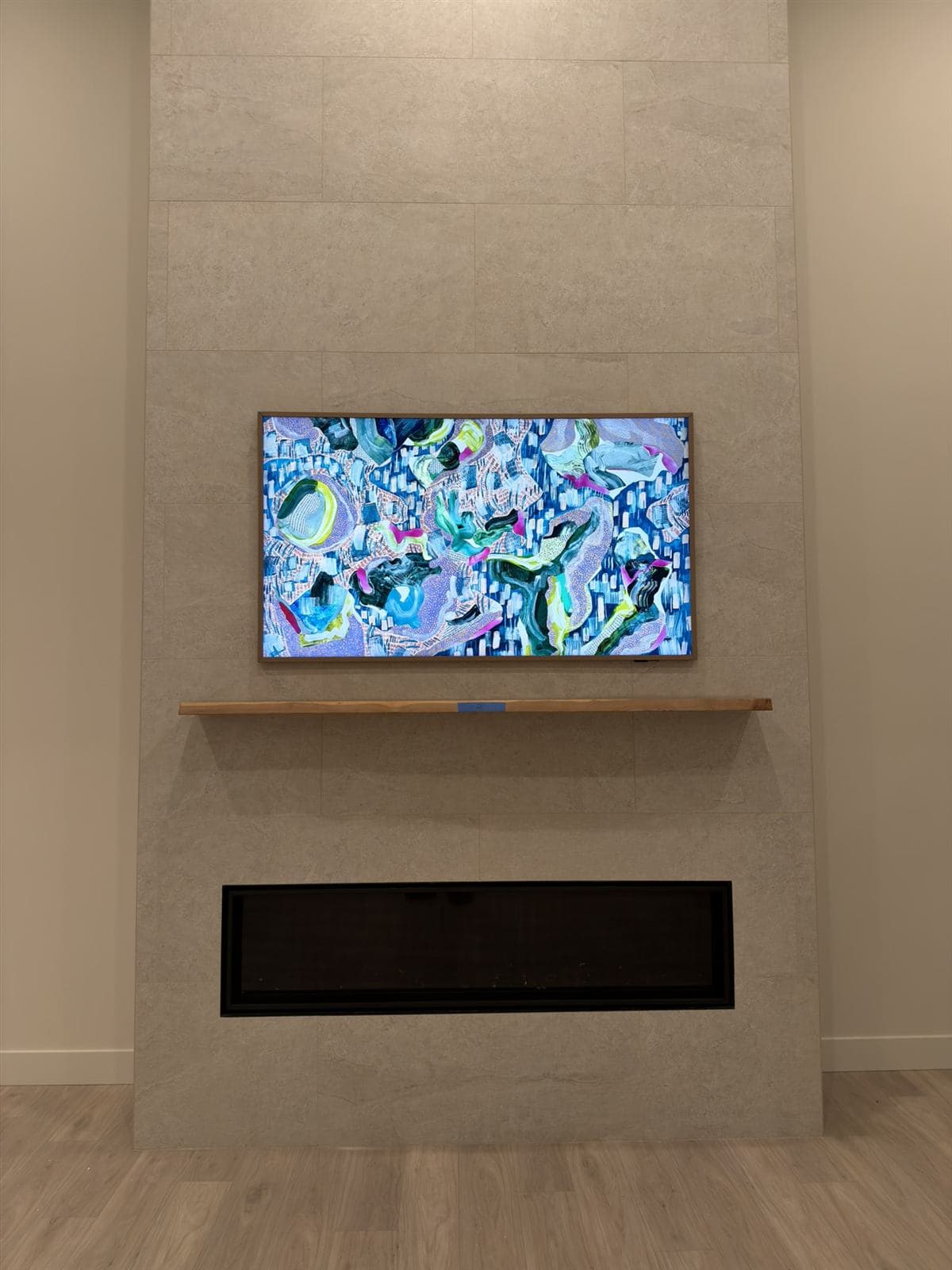 Frame TV with concealed wiring on a tile feature wall