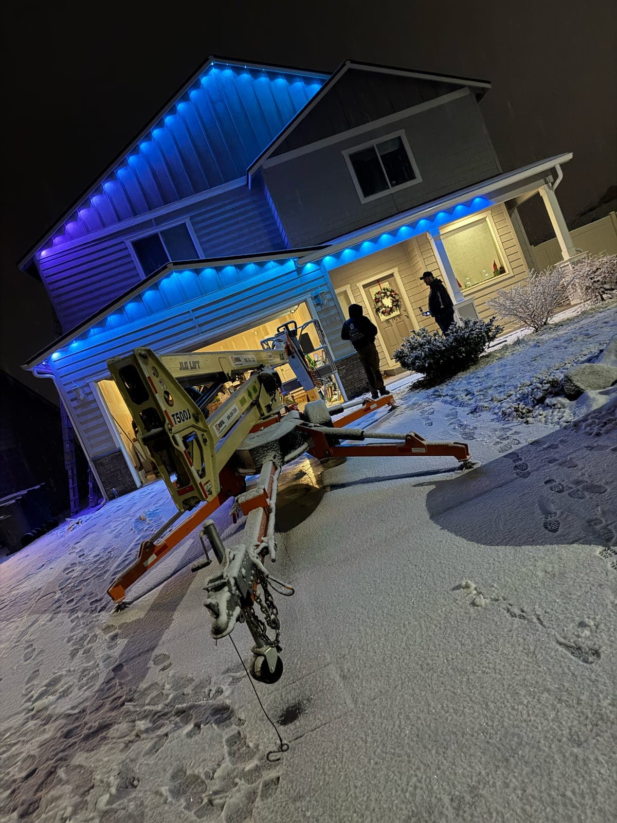 Installing permanent lighting on a snowy evening