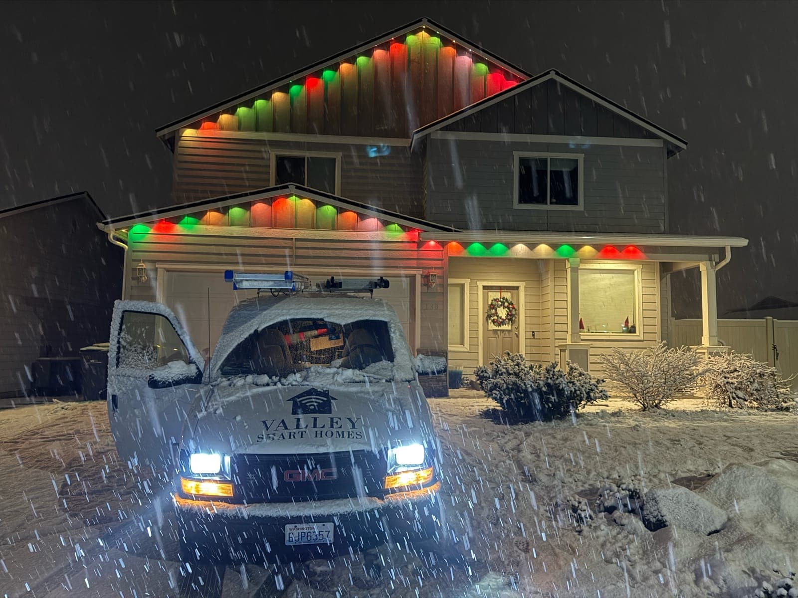 Red and green holiday scene on a snowy night