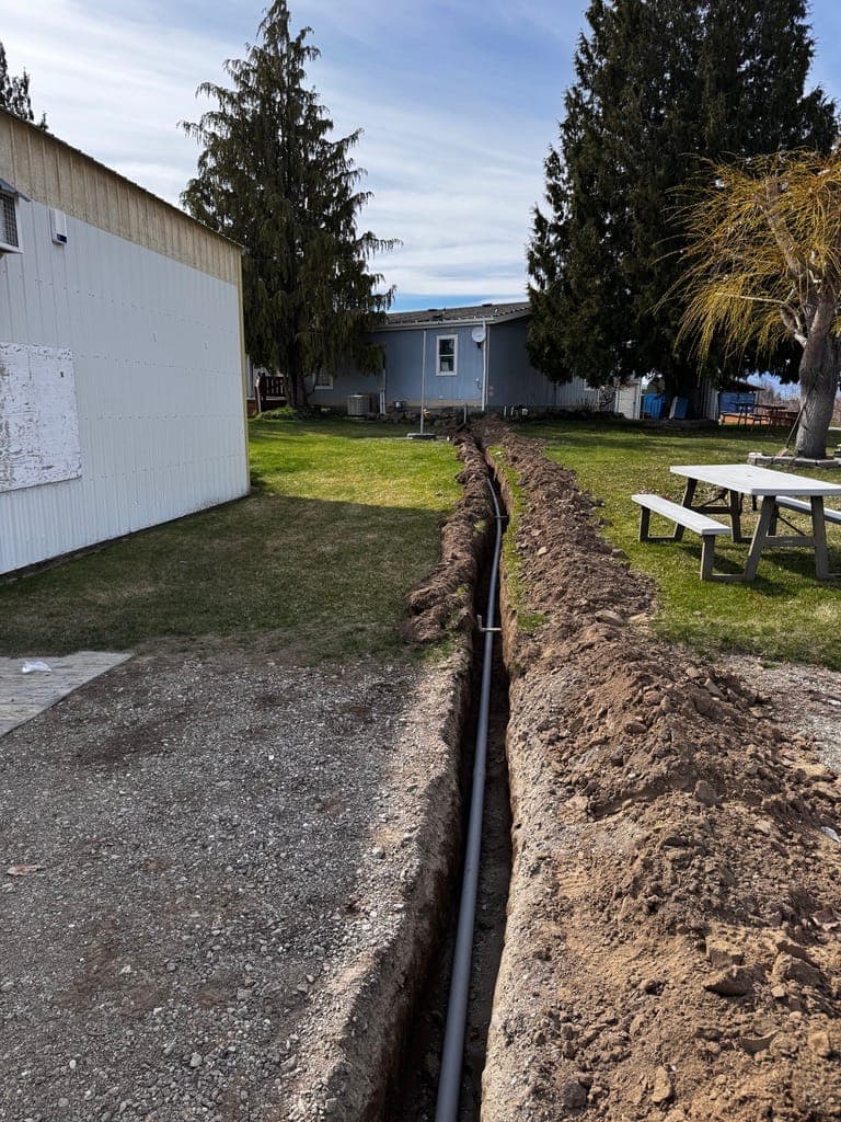 Conduit trench from the outbuilding to the house